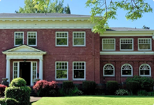 Chosen Wood Window Maintenance van parked in front of a red brick building with multiple windows featuring WindowSLIP installed.